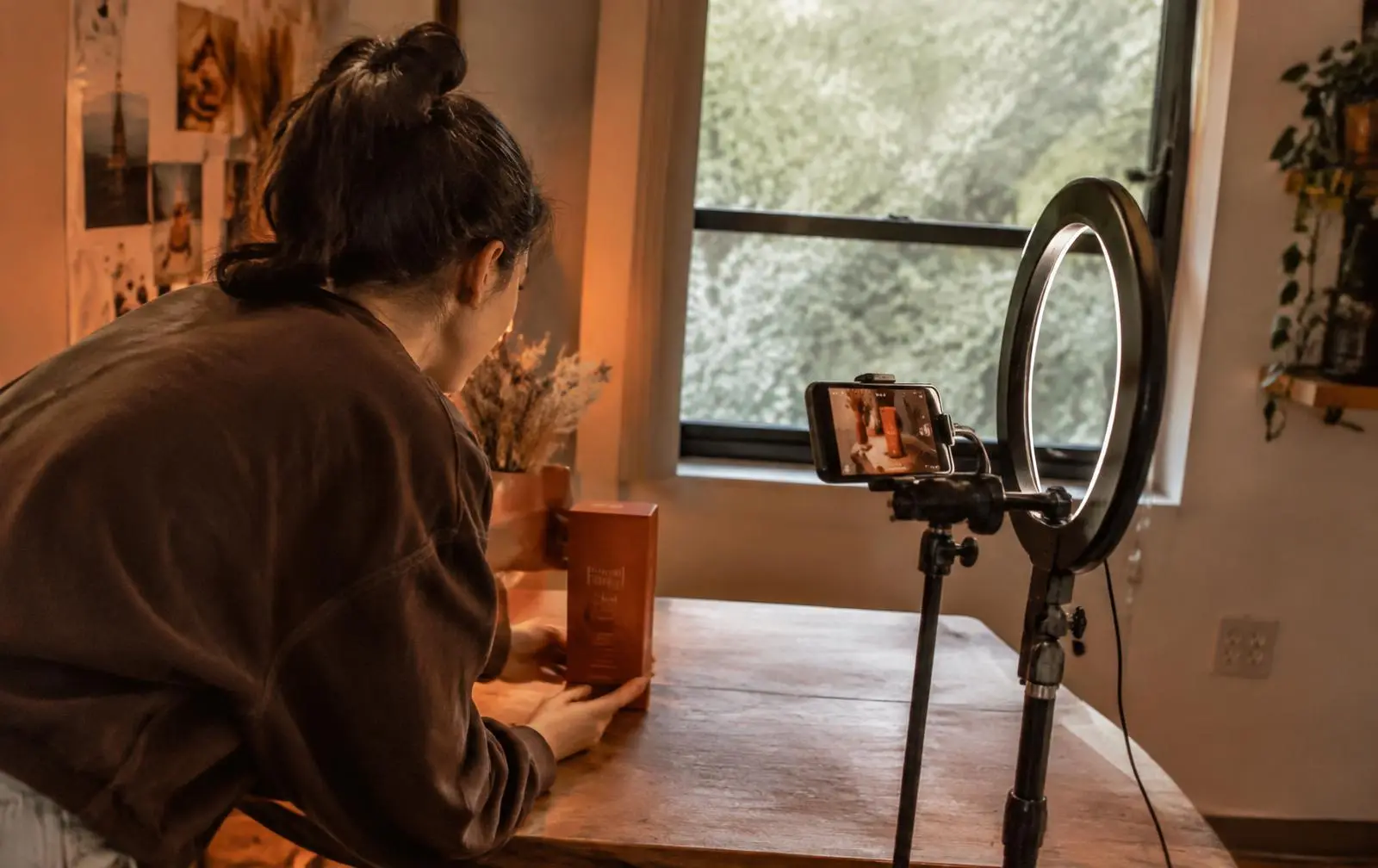 A founder photographing new product packaging in a small home studio