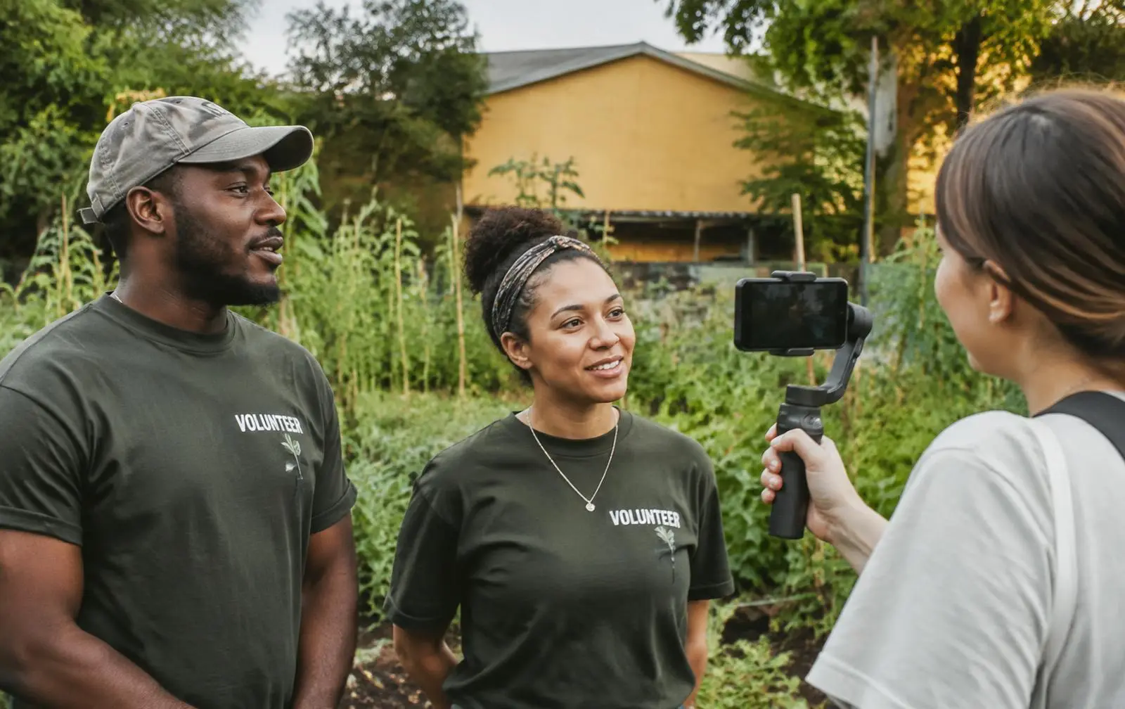 Volunteers being interviewed on camera at a community garden